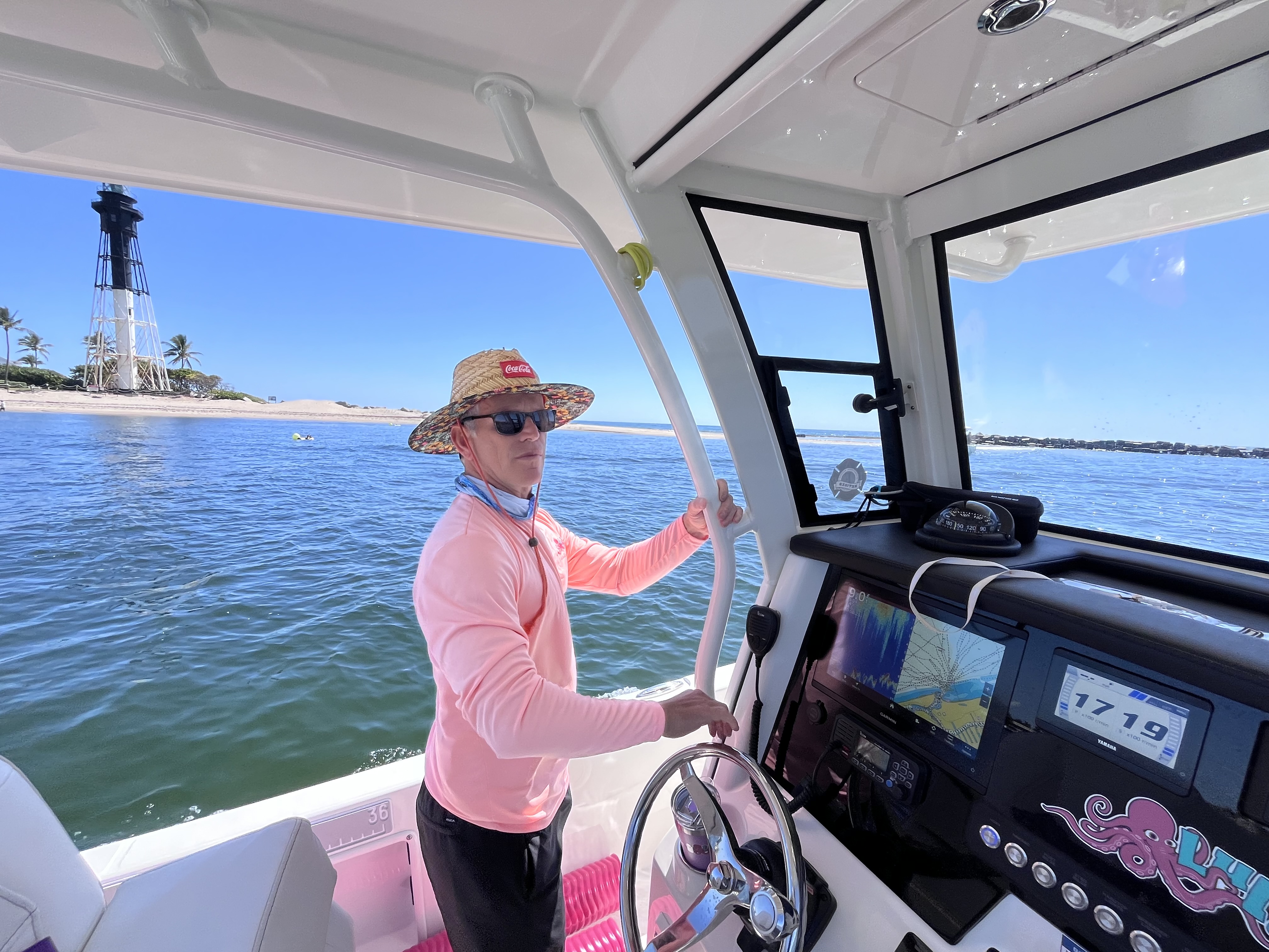Your captain at the helm of the Lulu charter boat near Hillsboro Lighthouse