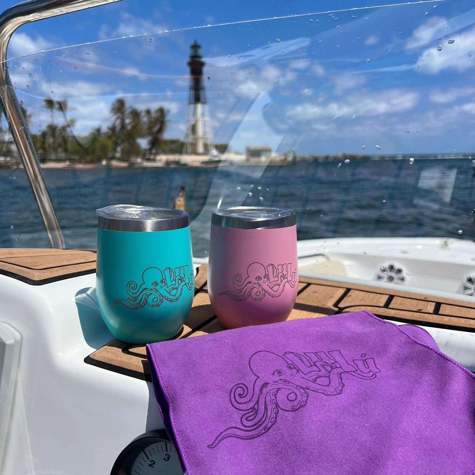 Lulu Boat Charter branded cups on the boat at Hillsboro Lighthouse — celebrating on the water